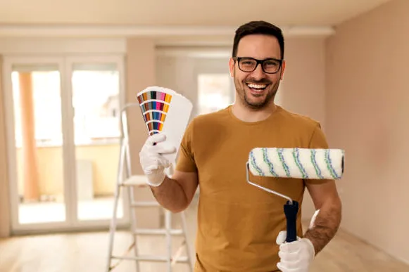 Painter holding a fan deck of colors